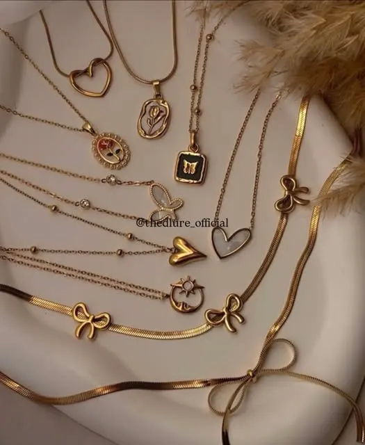Charm pendant chains laid out: hearts, bows, tulip and butterfly